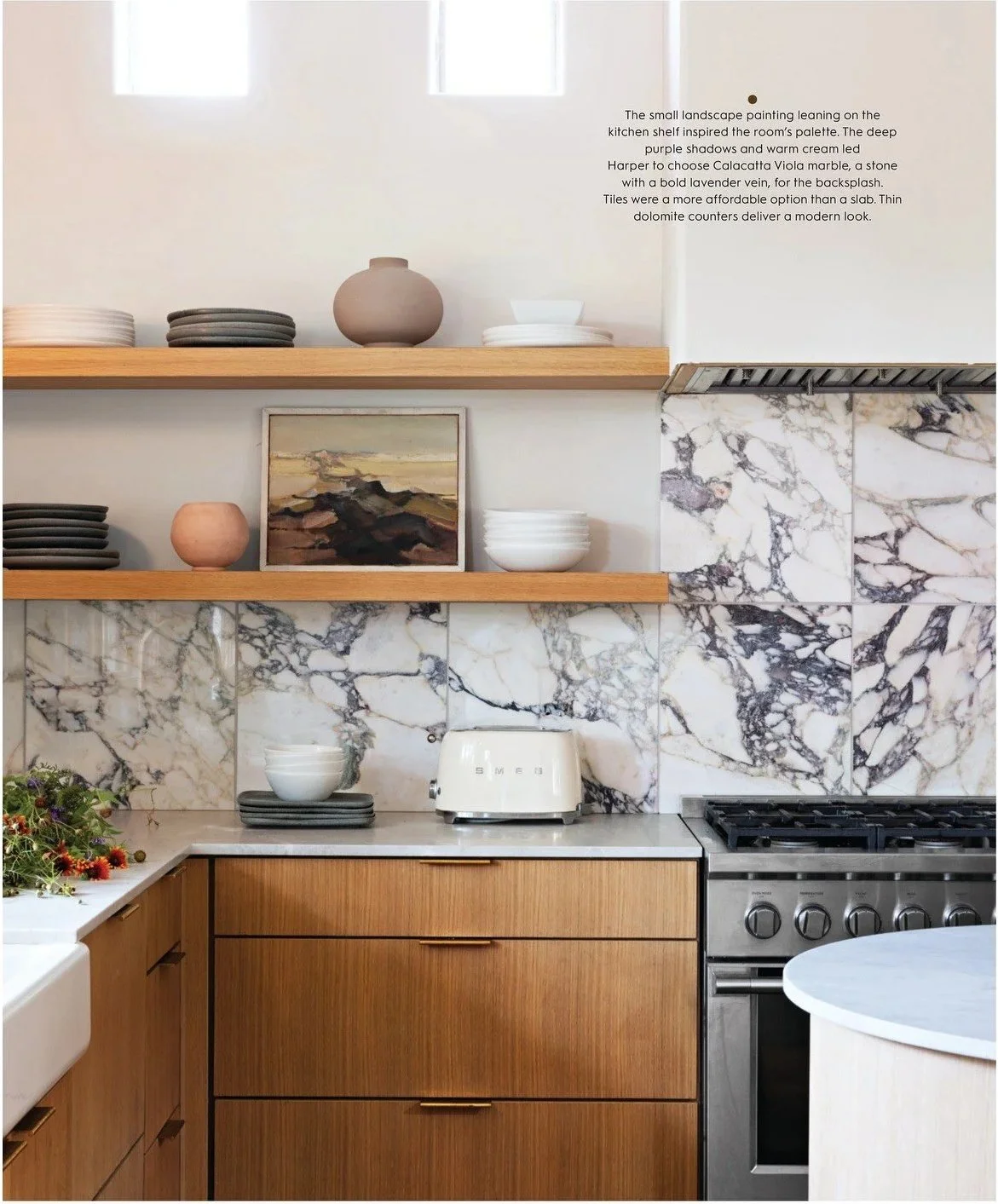 Oak kitchen shelves against dramatic veined stone backsplash