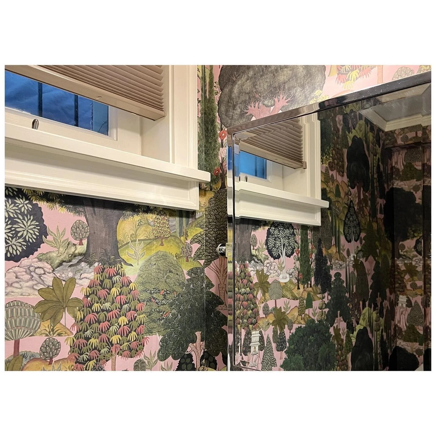 Patterned wallpaper continuing around a high bathroom window
