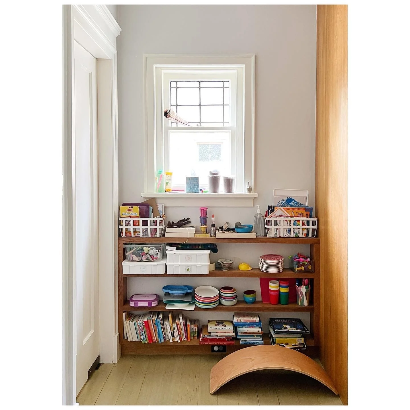 Original kitchen nook with a low bookcase and a small timber arch