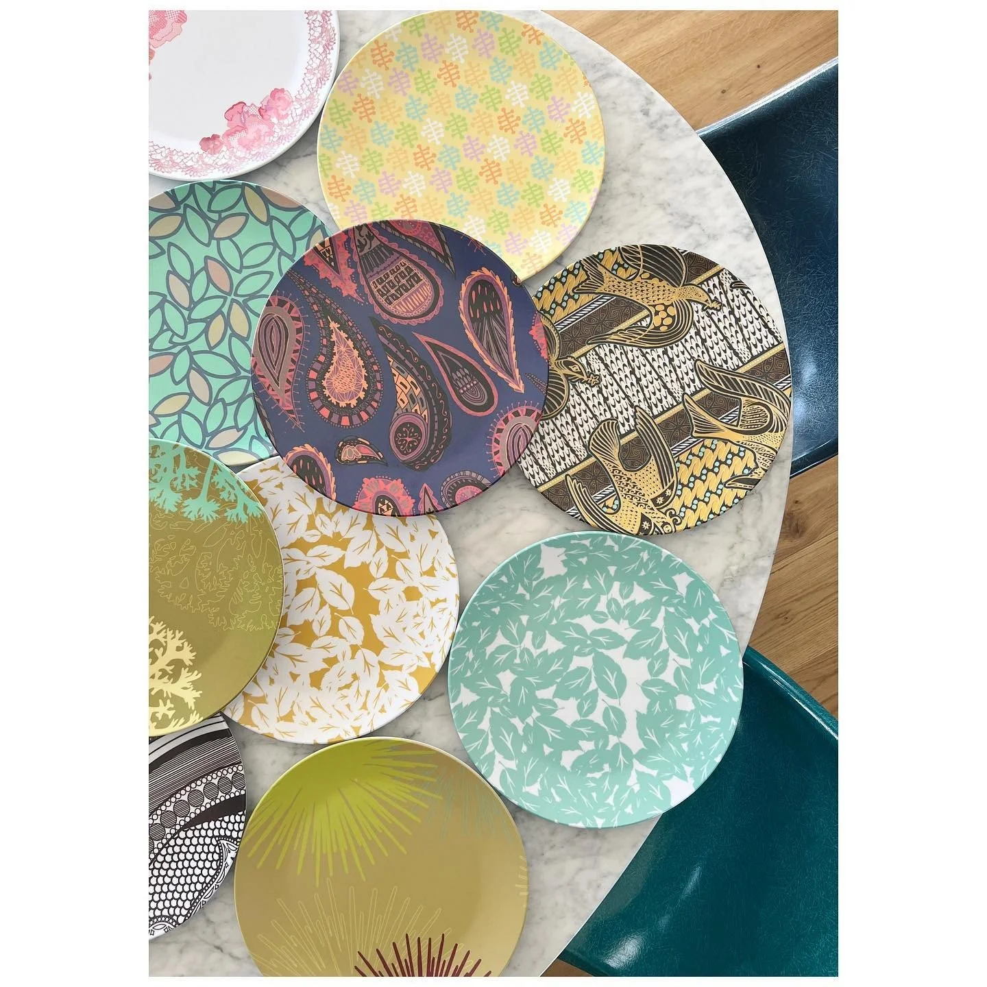 Overlapping round fabric and printed material samples in varied colors and patterns