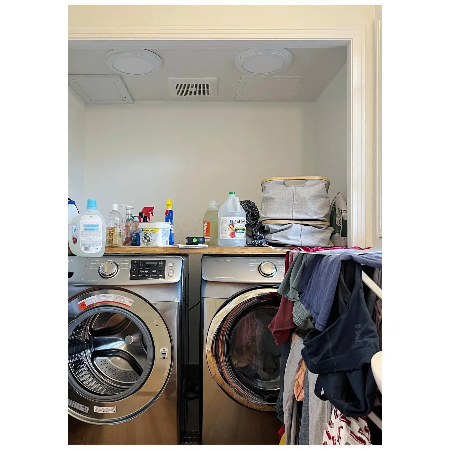 Laundry room before the refresh with front-loading appliances and a narrow pale-walled niche