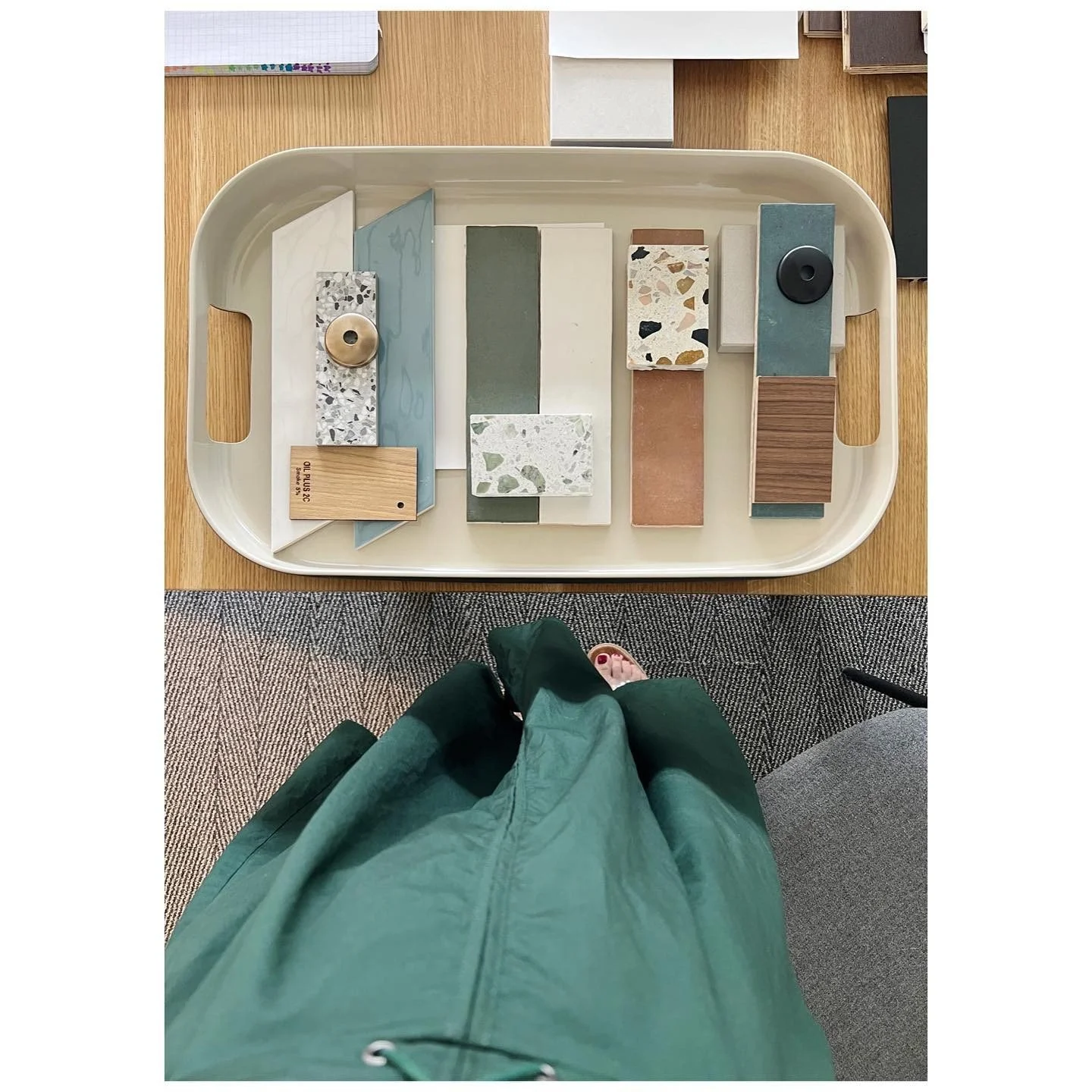 Tray of terrazzo, stone, green paint and timber material samples arranged for a project palette