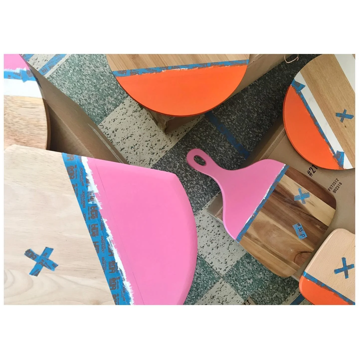 Cutting boards masked and painted in vivid pink and orange