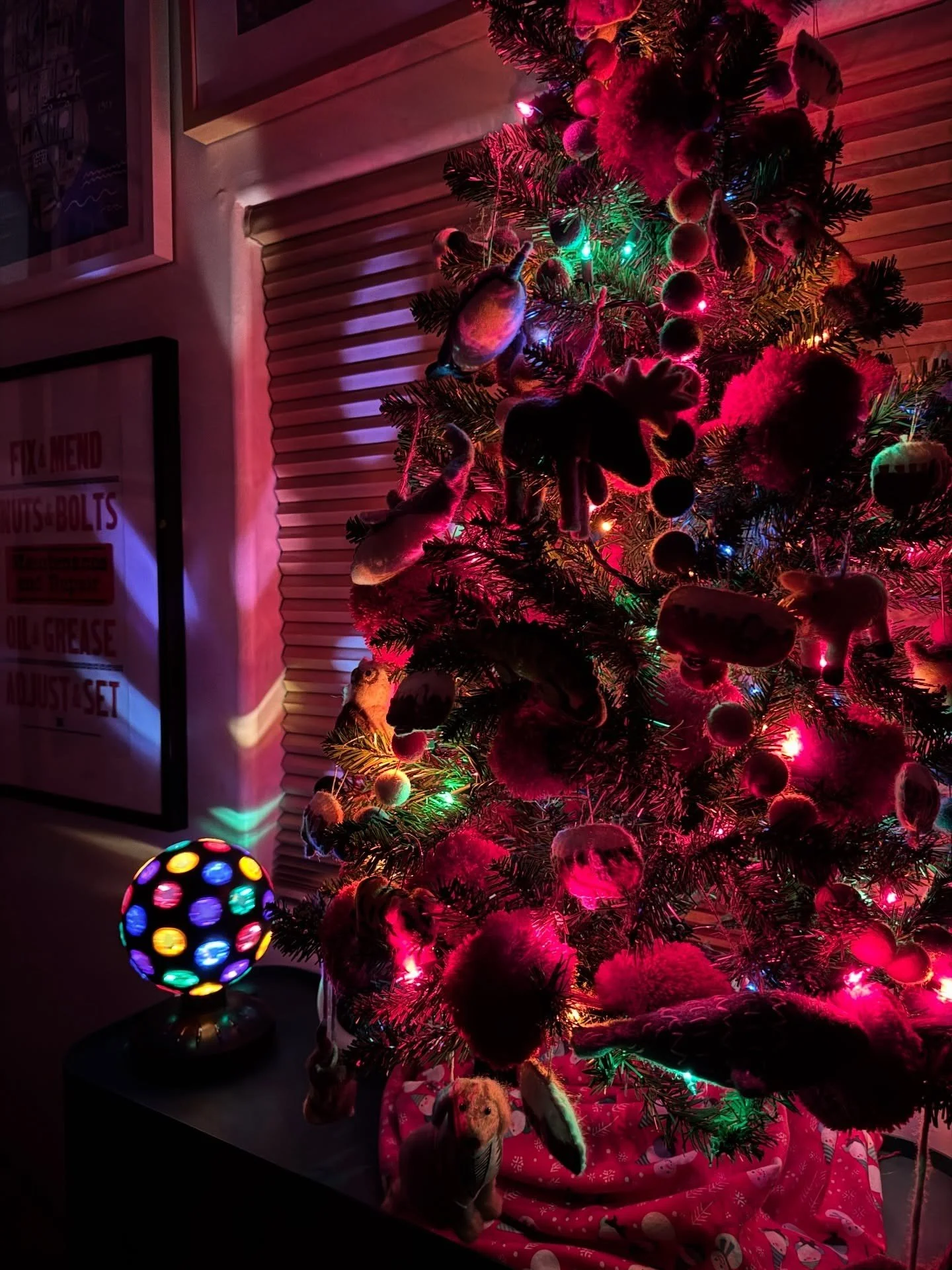 Close-up of a Christmas tree with red ornaments and lights