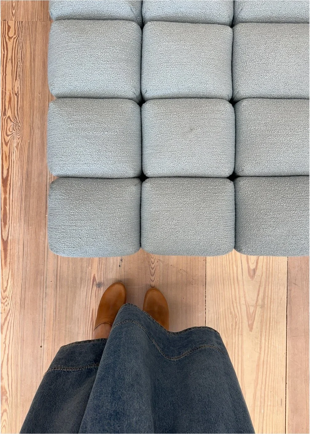 Grid of pale upholstered seat cushions beside a wood frame