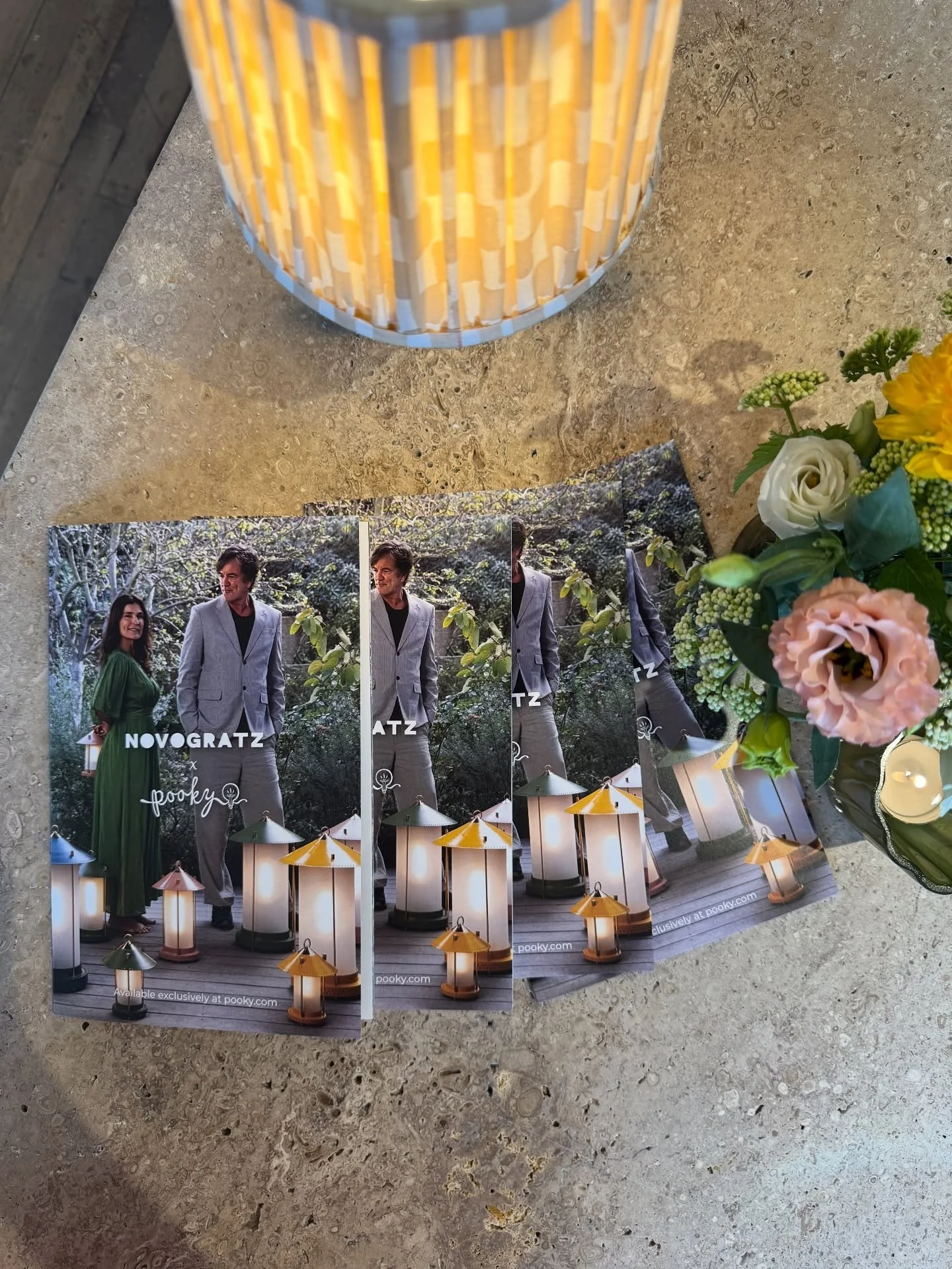 Design book and fluted lamp beside a flower arrangement