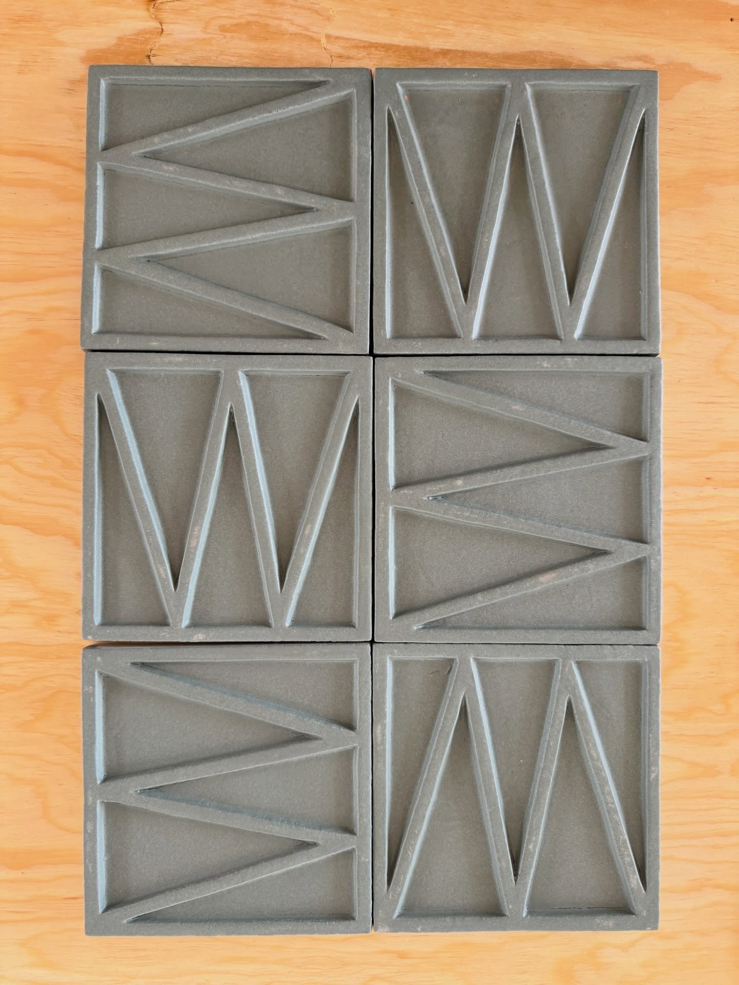 Gray relief tiles arranged in a rectangular grid