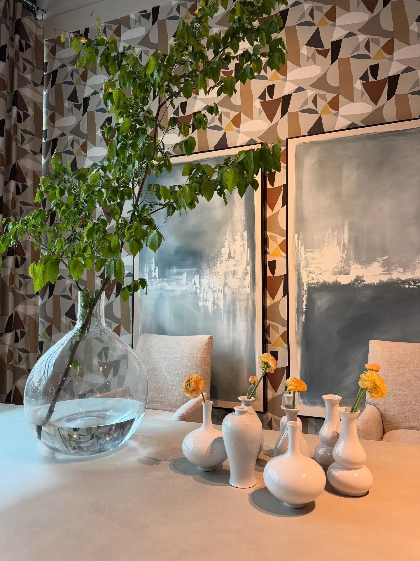 Stone counter styled with a glass vase candles and branches