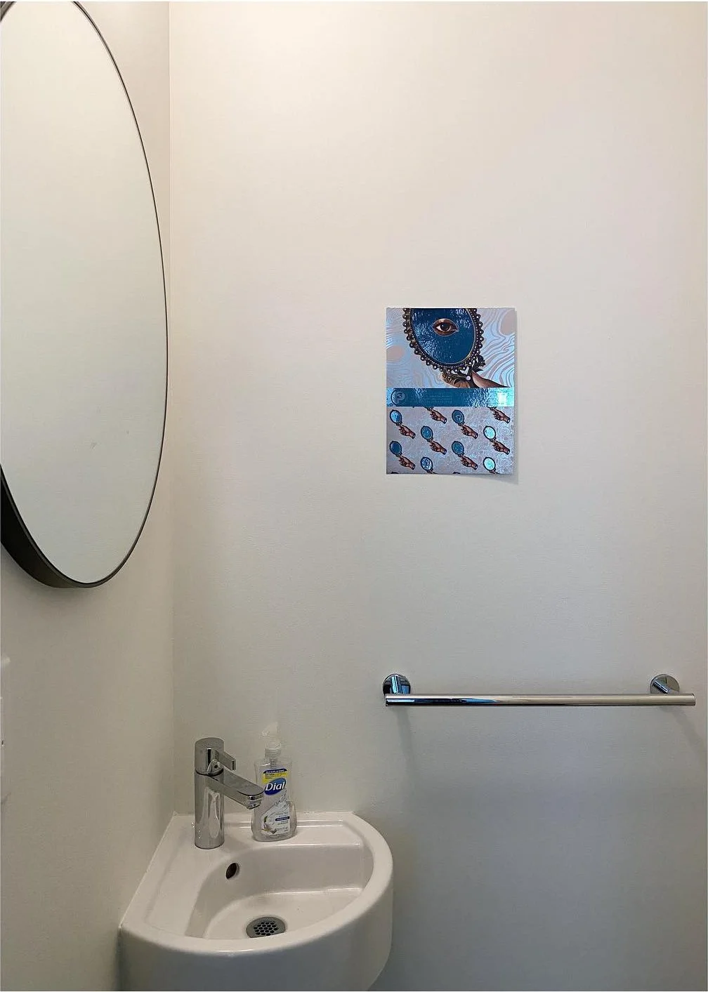 Original plain powder room with pale walls and a small white basin