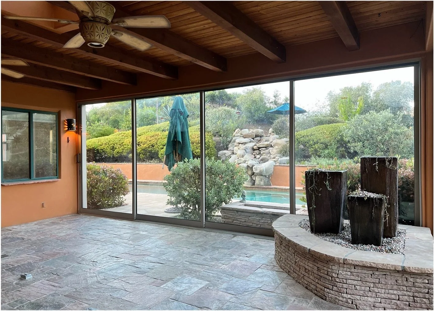 Original indoor stone water feature beside large garden windows