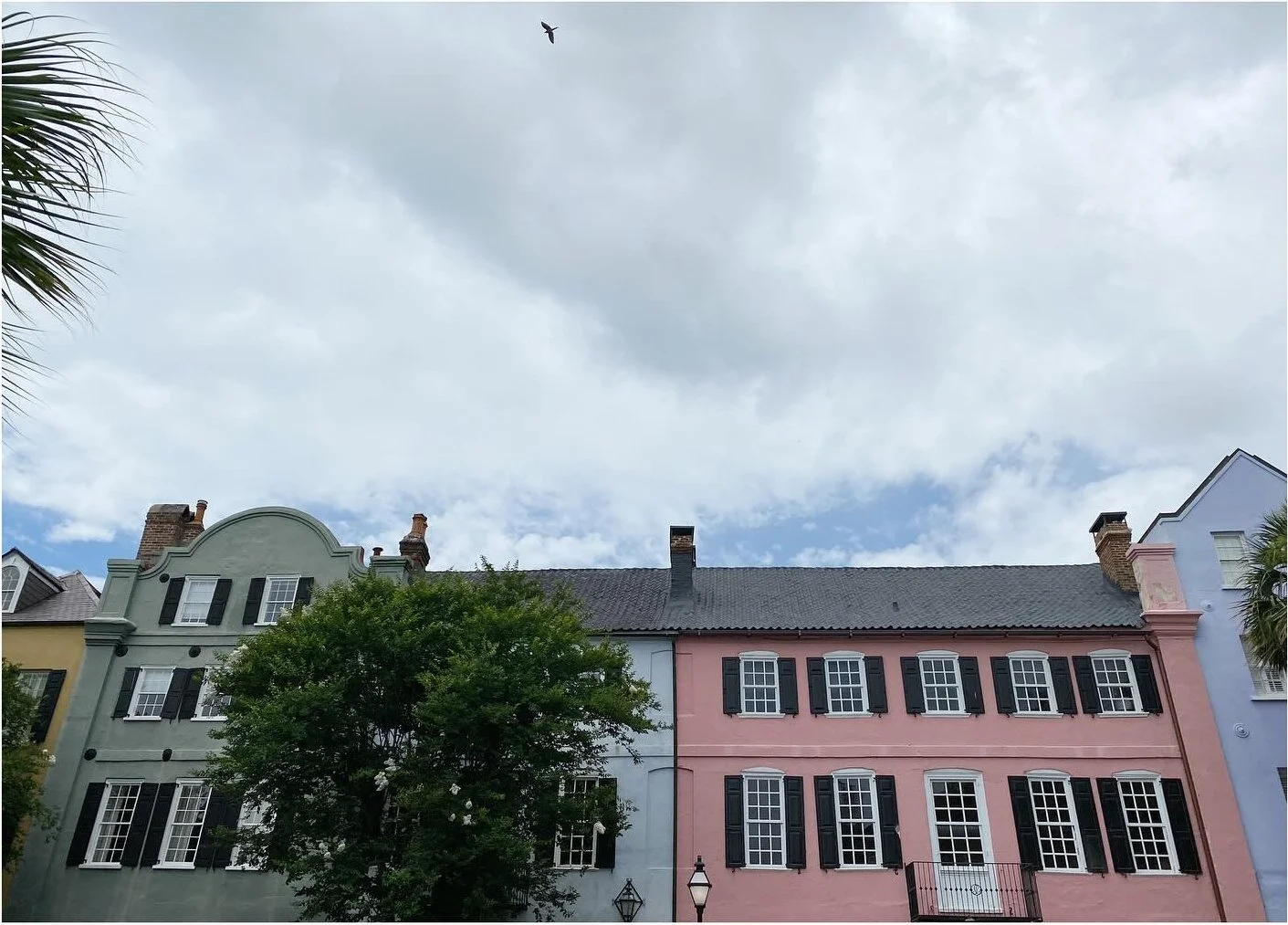 Row of colorful historic facades beneath a cloudy sky