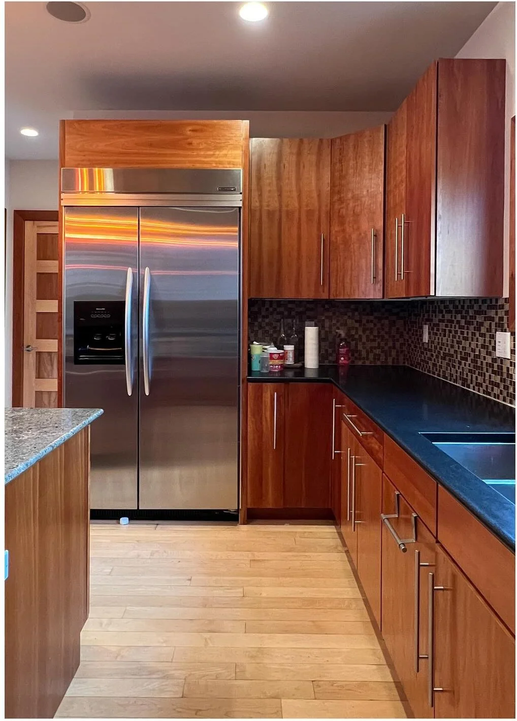 Original kitchen with dark wood cabinetry and stainless steel refrigerator