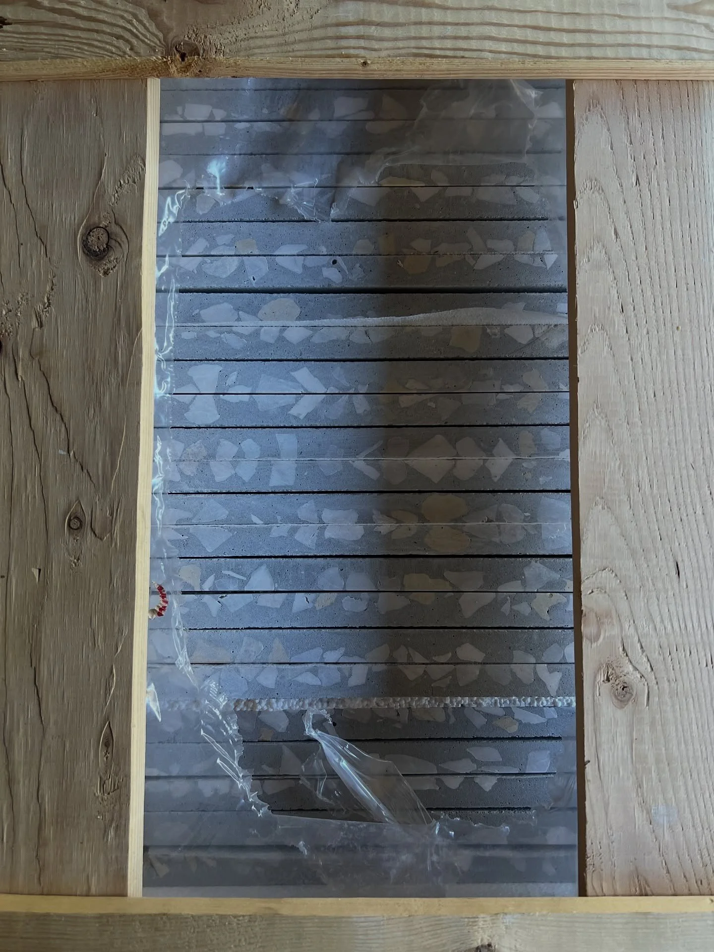 Tile sample board with pale glossy rectangular tiles