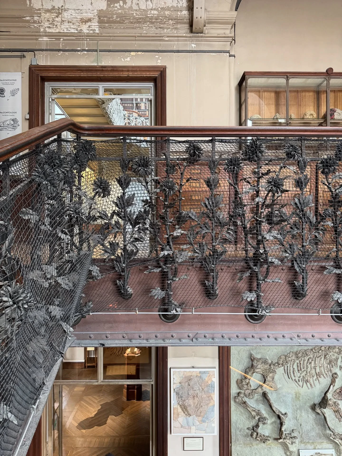 Decorative iron balustrade overlooking museum exhibits