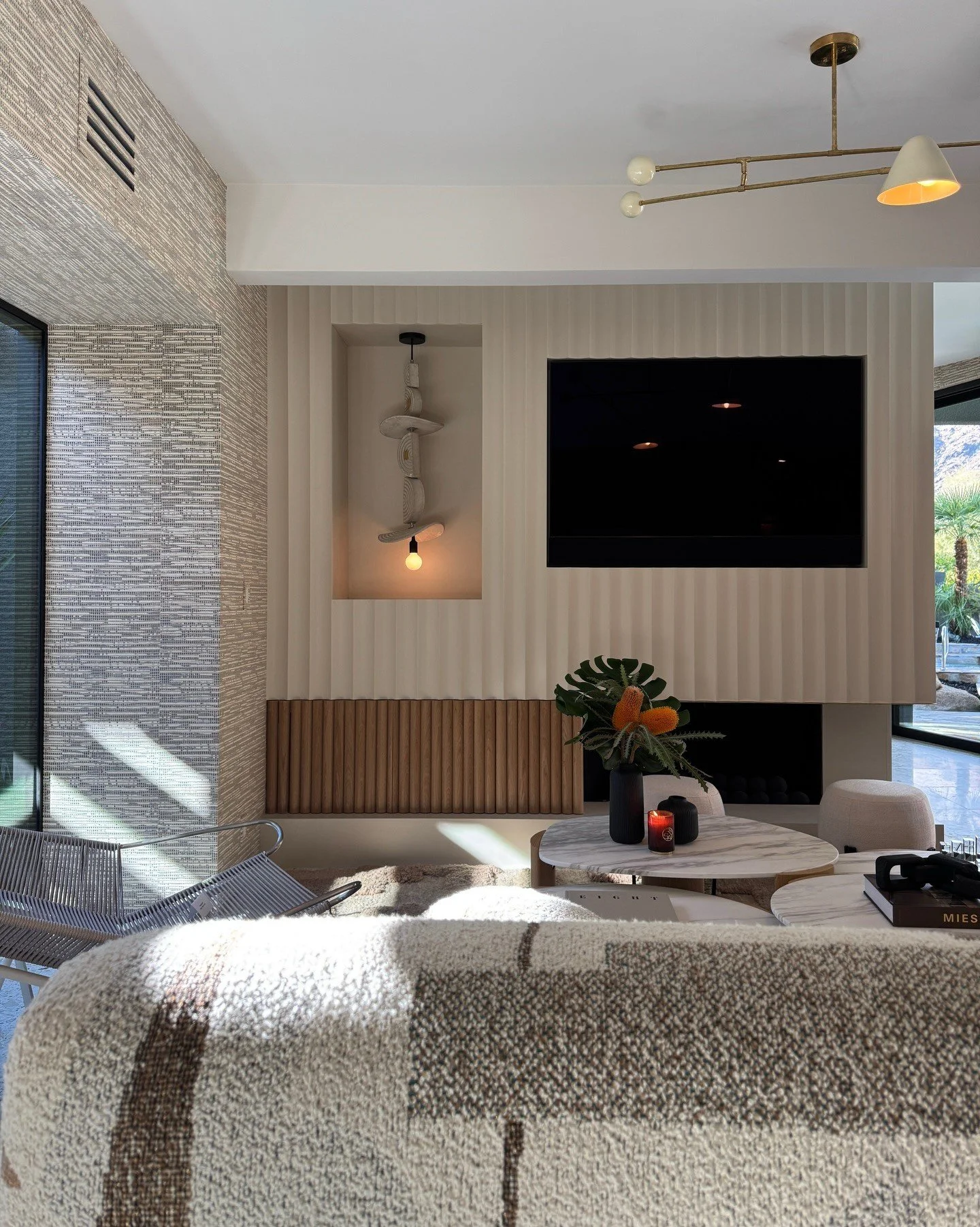 Pale upholstered sitting area with wood media cabinetry