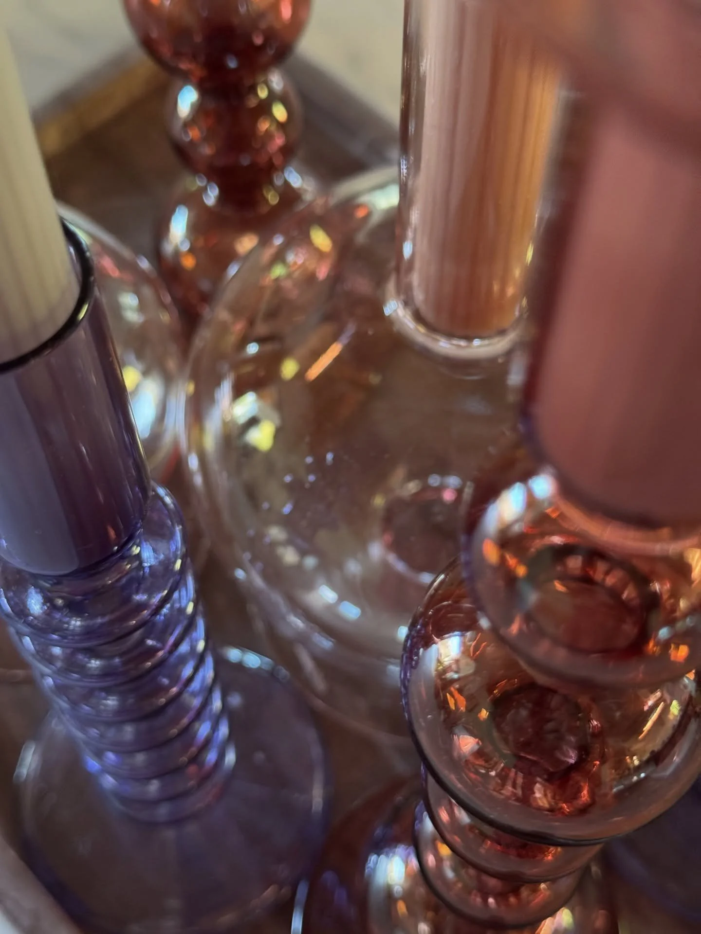 Colored glass candleholders with pink taper candles