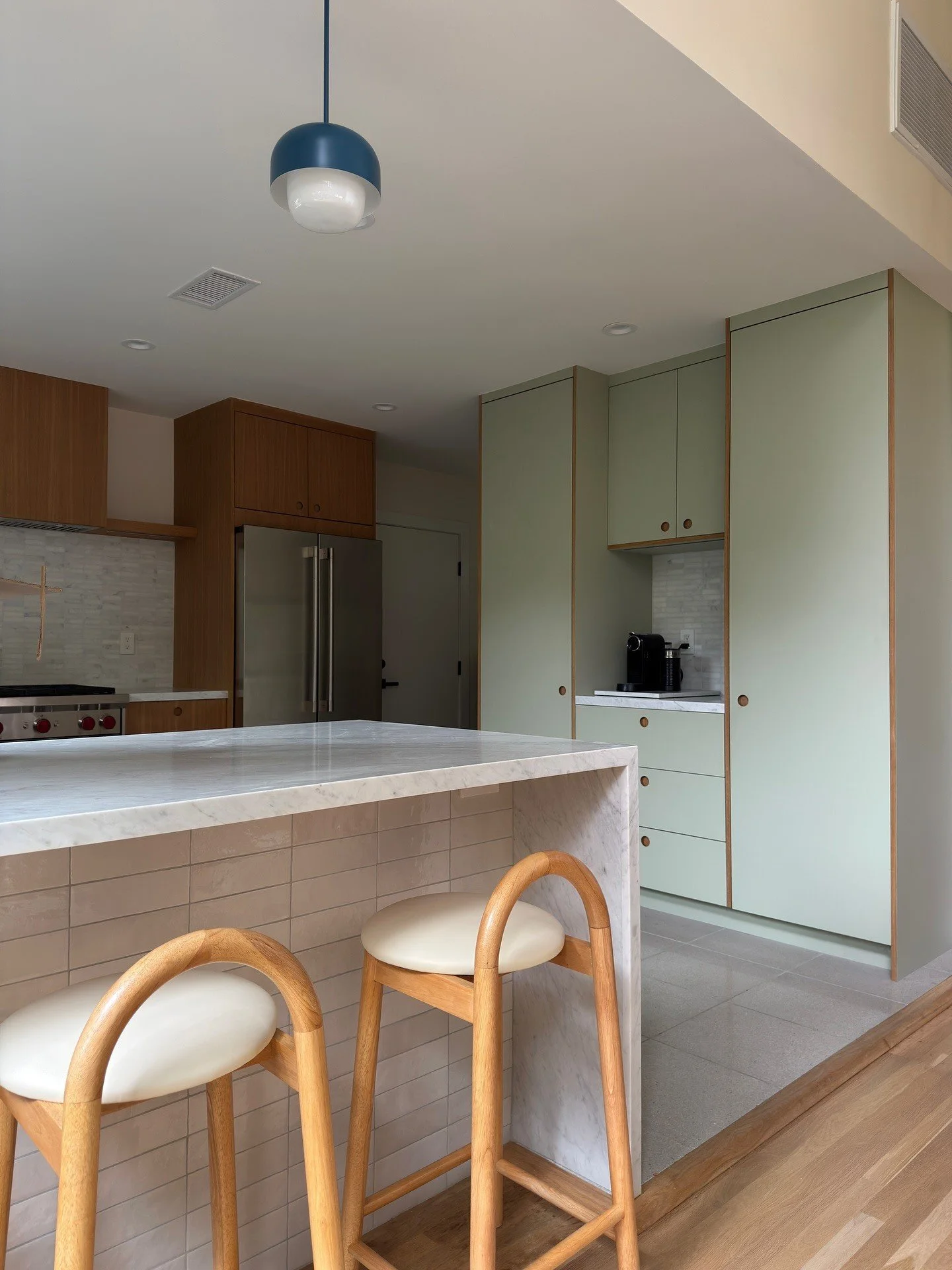 Renovated oak kitchen island with curved wood bar stools