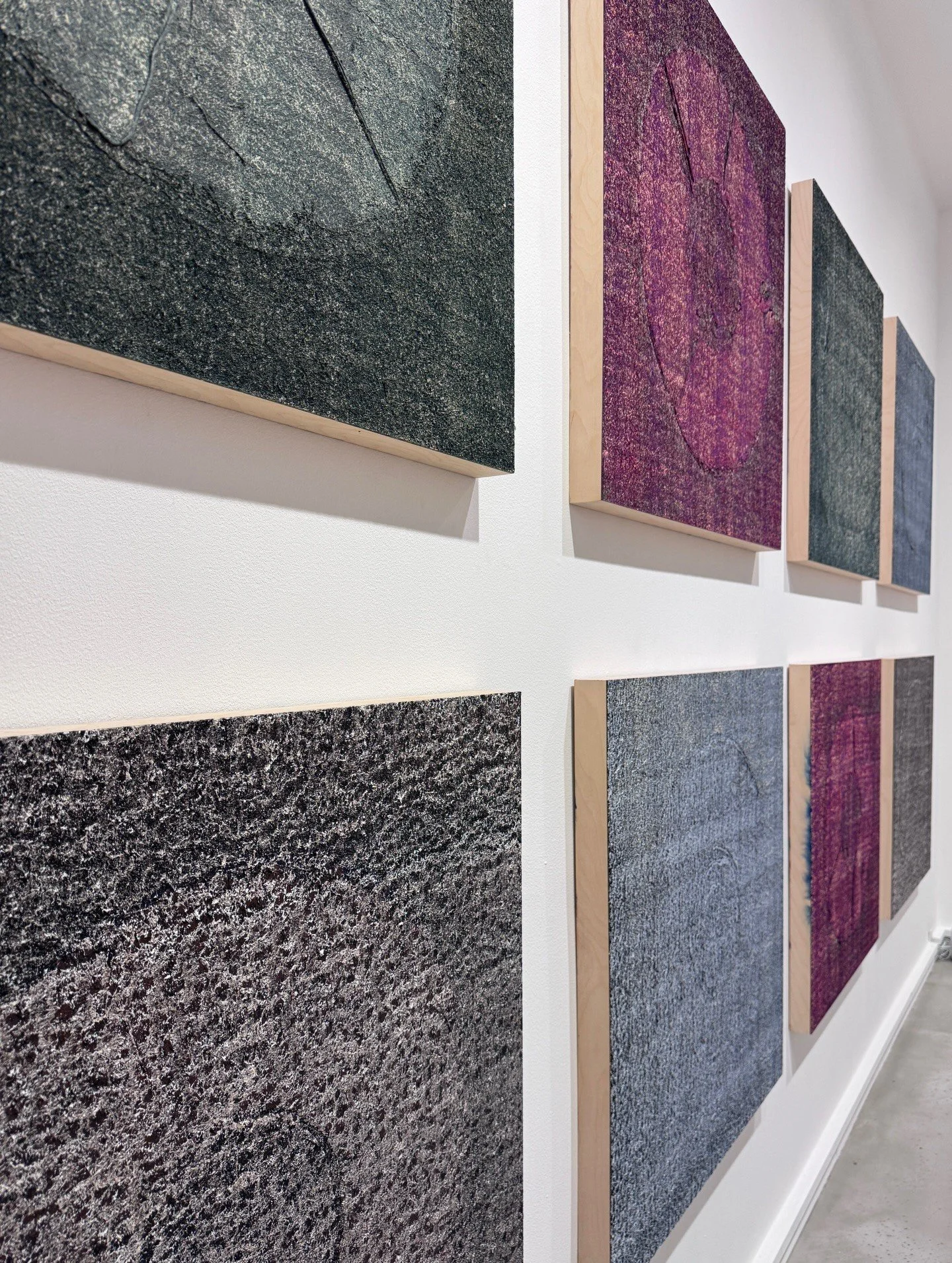 Textured abstract panels in charcoal purple and ochre tones