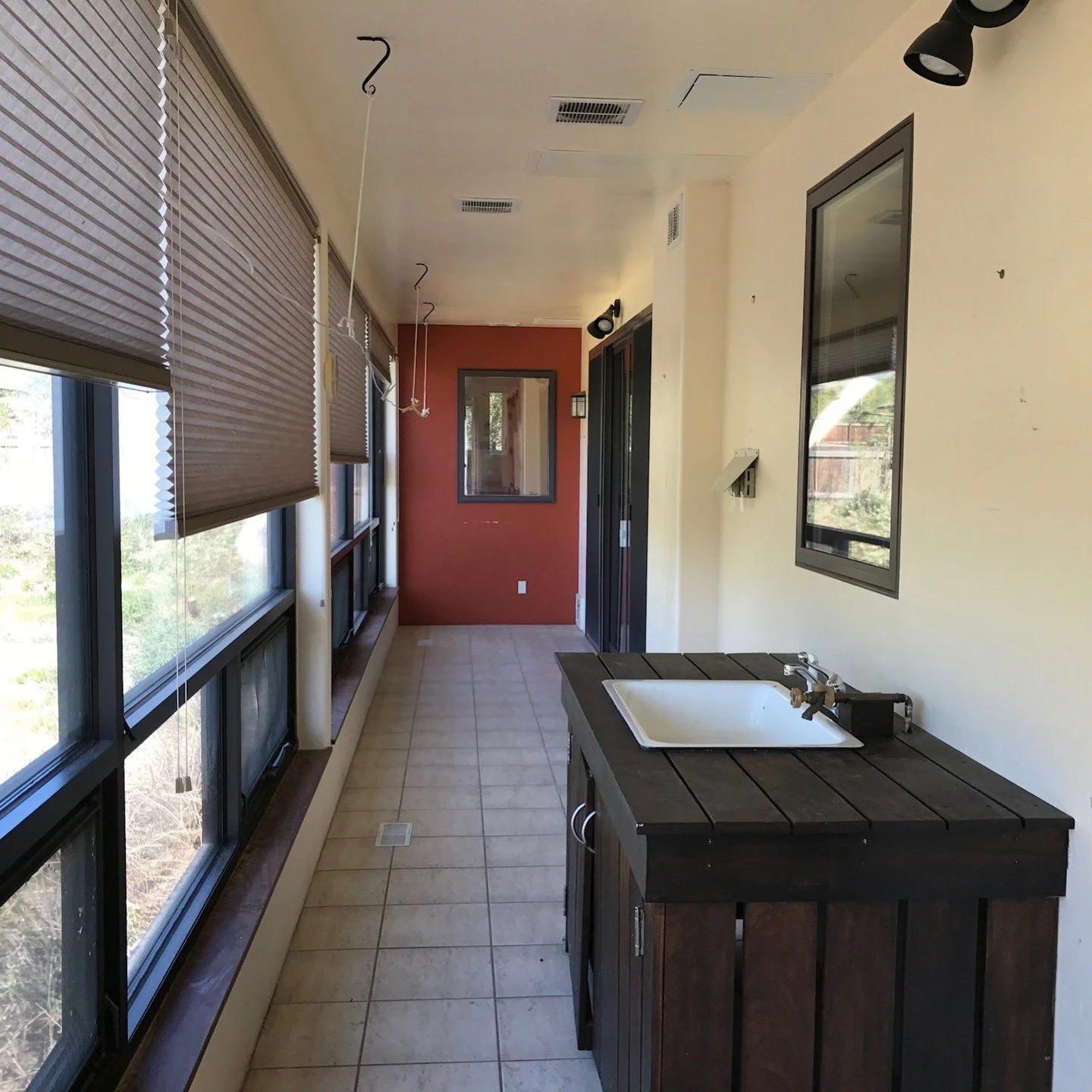 Original tiled sunroom with black-framed windows