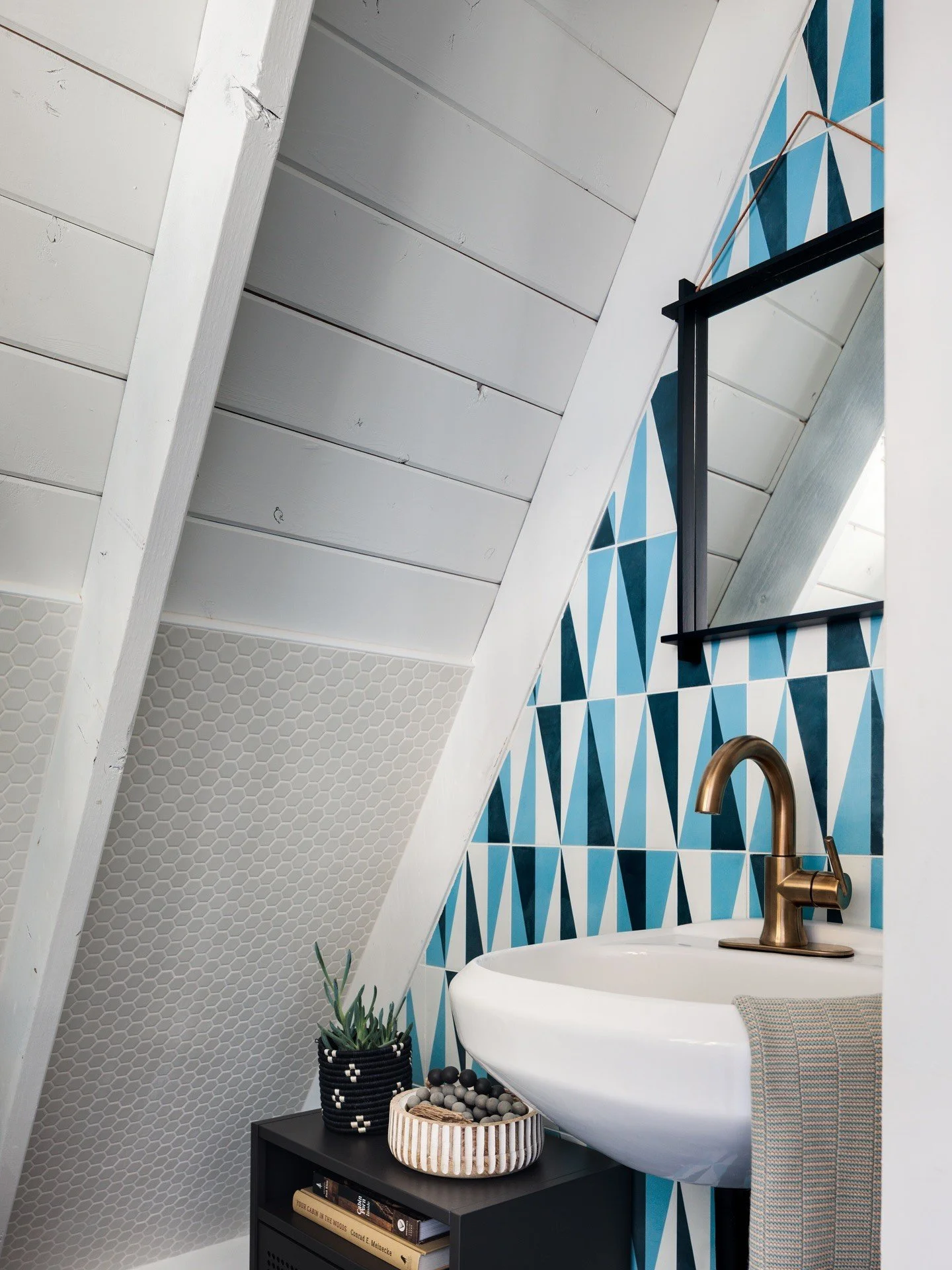 Blue geometric tile wall beneath a sloping white ceiling