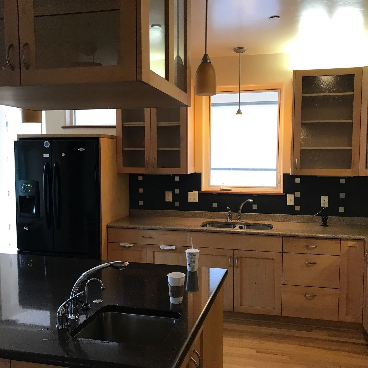 Original wood kitchen cabinetry with a dark countertop