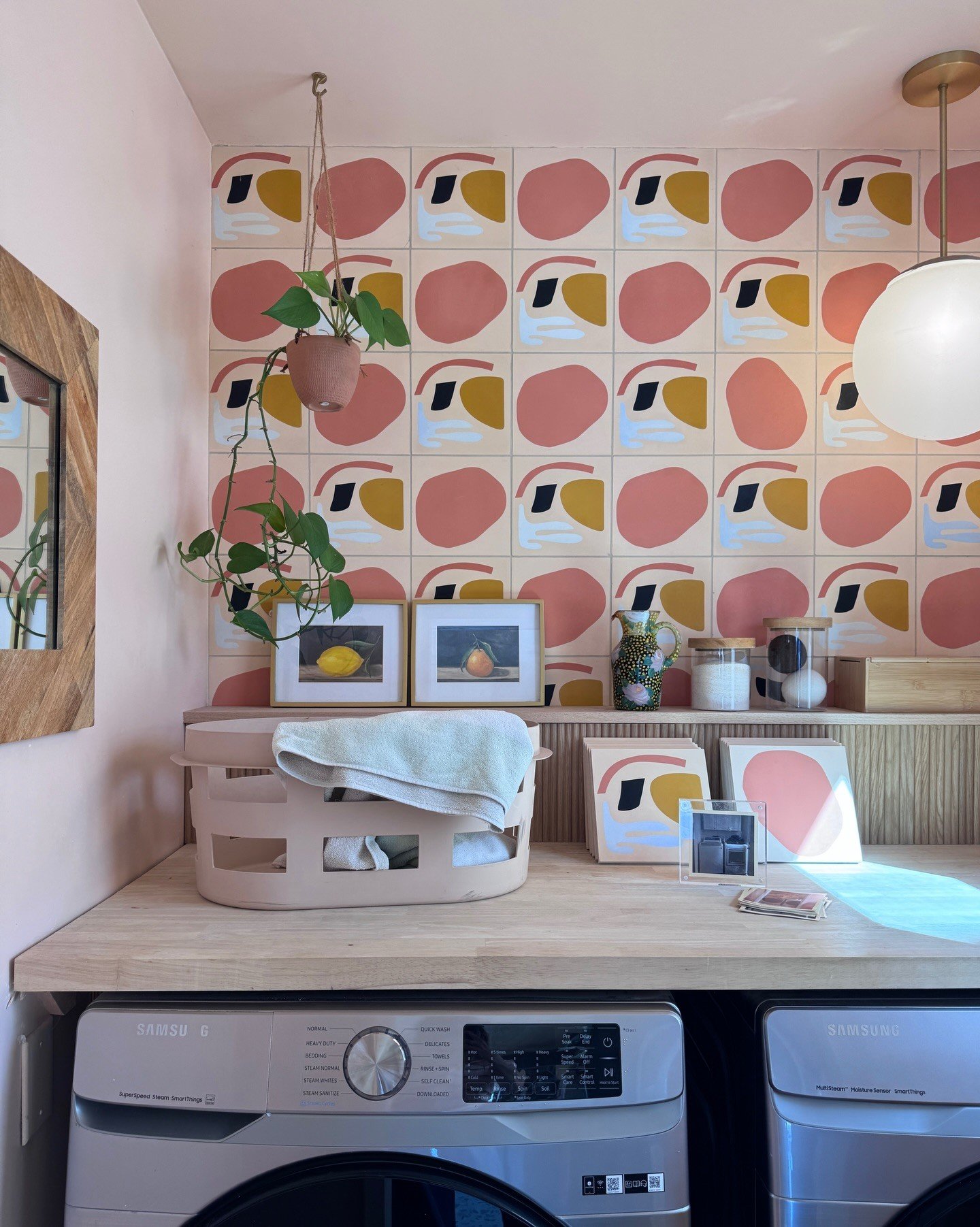 Laundry counter with multicolored geometric wallpaper and washer