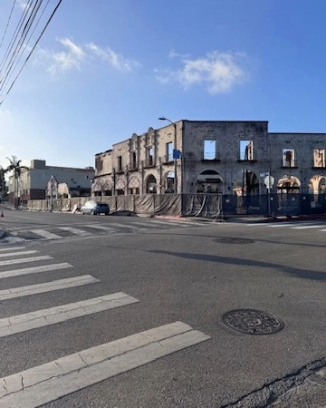 Brick buildings and a tree-lined street at an urban intersection
