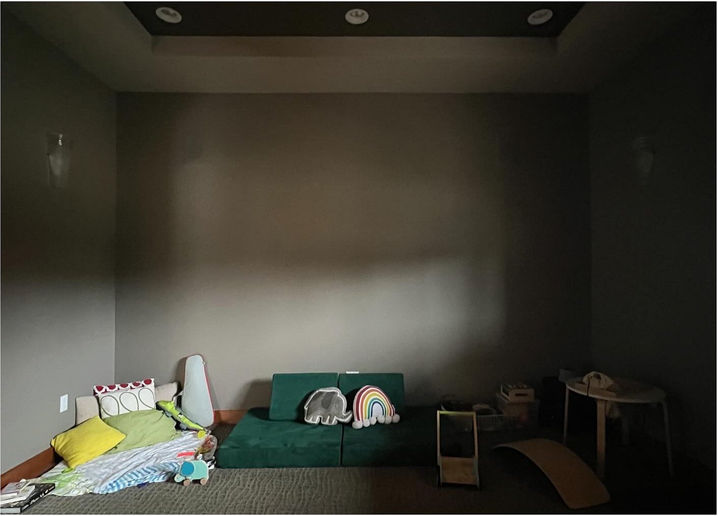 Original dark media room with toys gathered along one wall