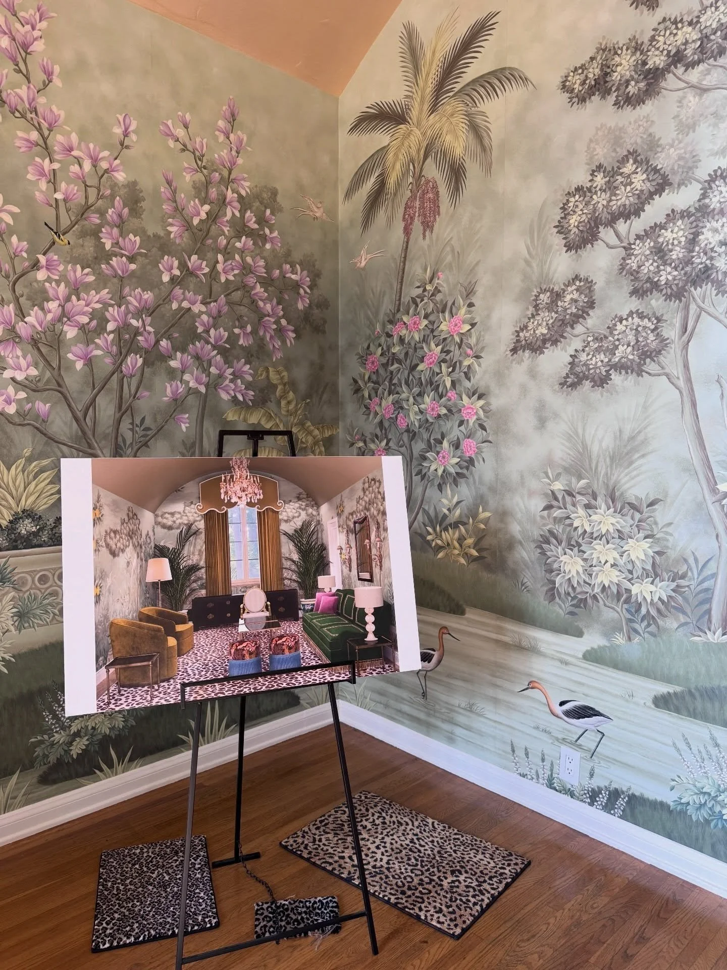 Scenic botanical wallcovering beside a small display table