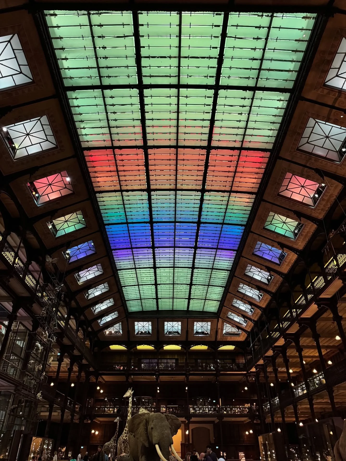 Long glazed museum roof lit in a rainbow of colors