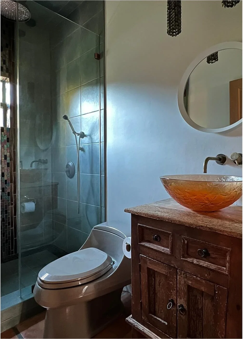 Original dark bathroom with glass shower and amber basin