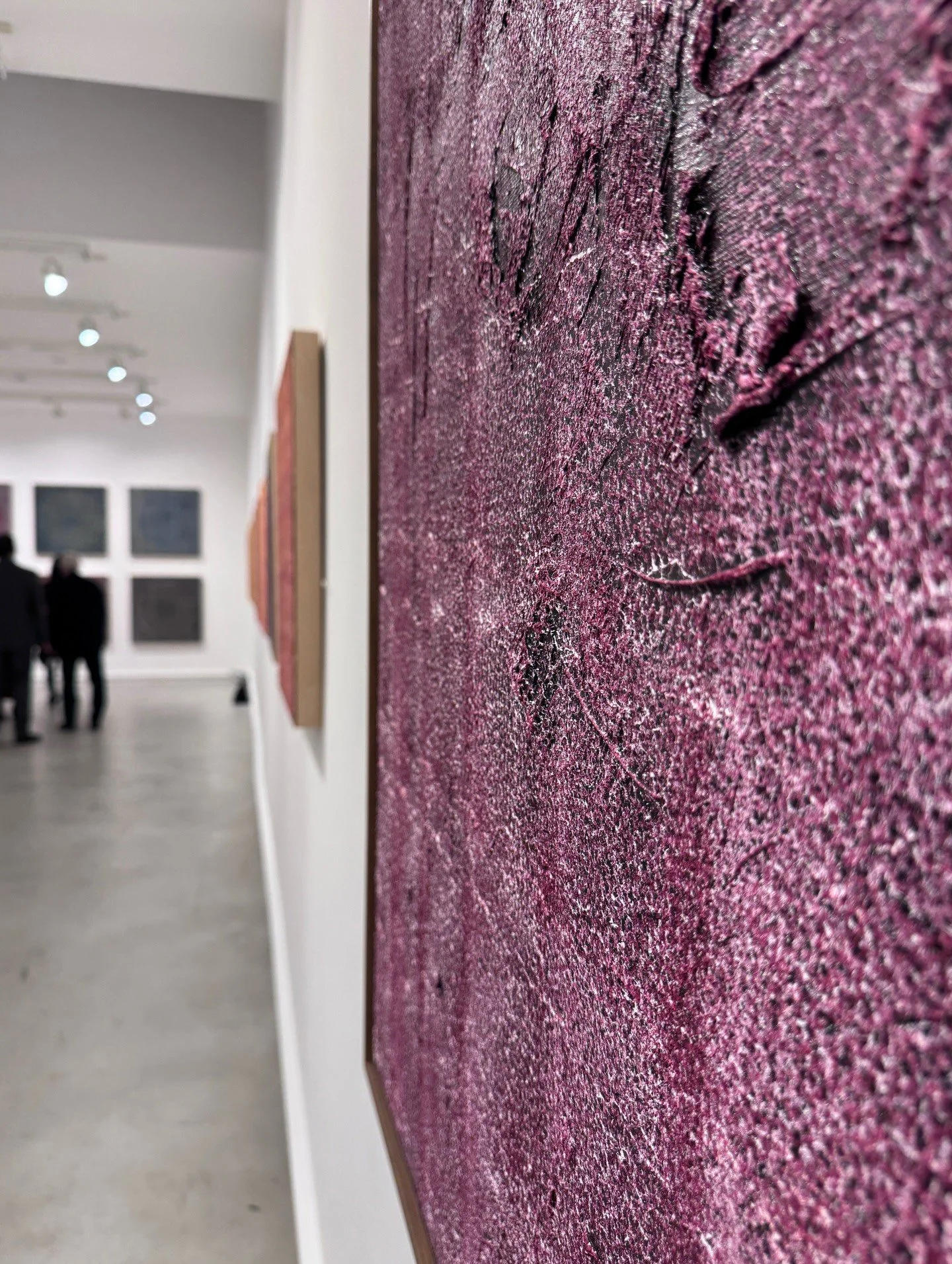 Close-up of raised texture on a purple abstract painting