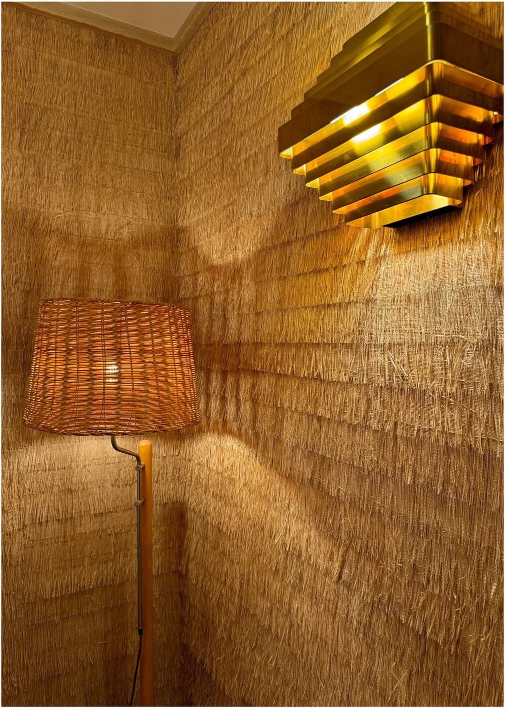 Textured ochre wall with a layered amber wall sconce