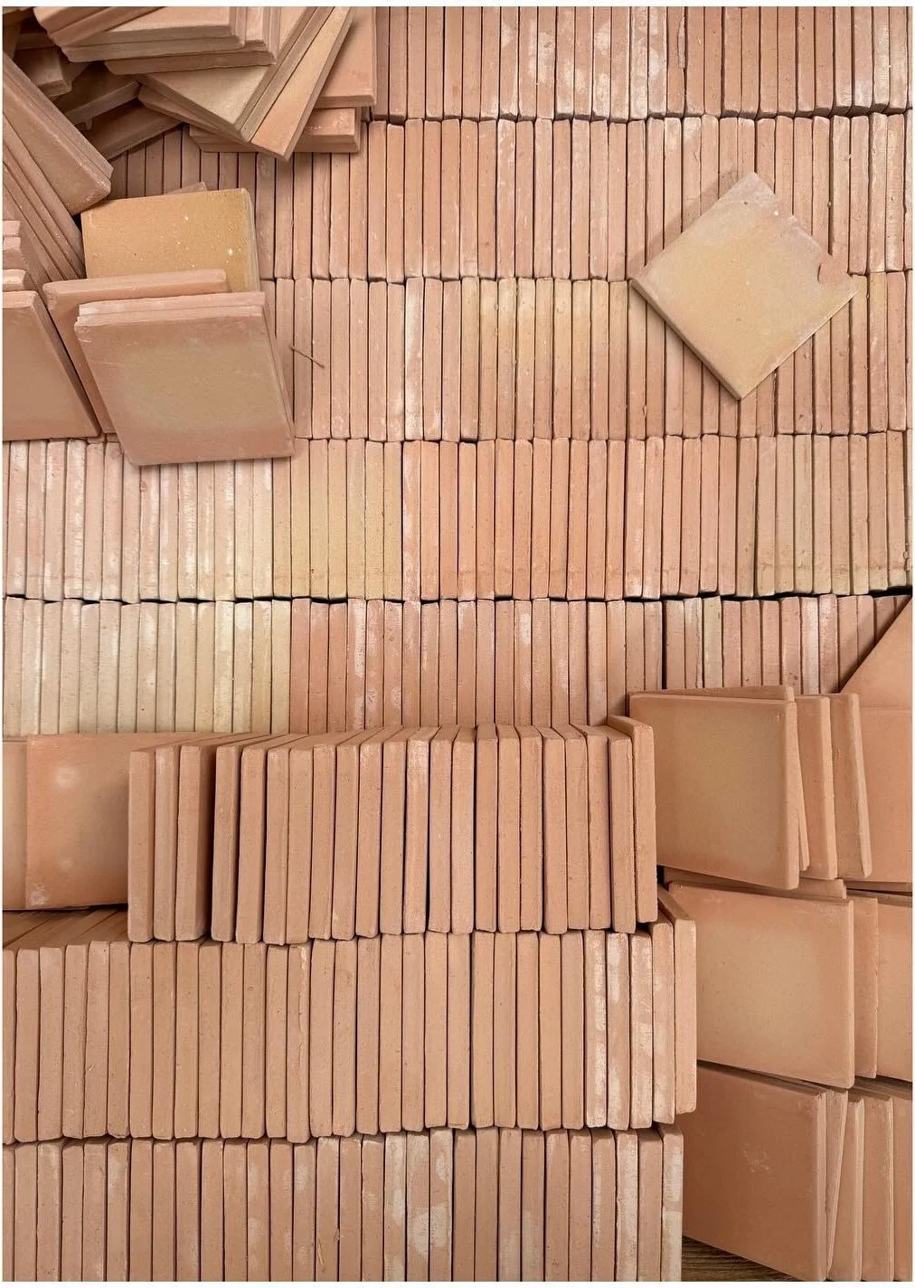 Terracotta wall with narrow relief tile strips and geometric accents