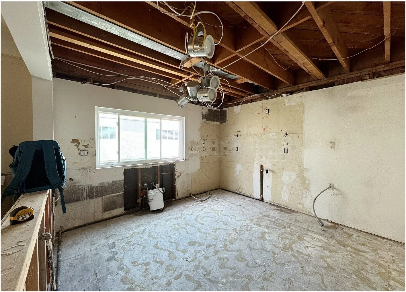 Kitchen demolition exposing timber ceiling joists and stripped walls