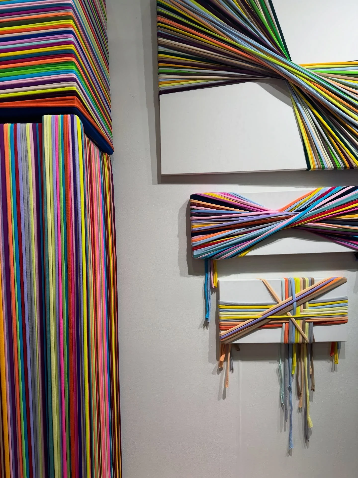 Striped multicolored wall installation with matching chair