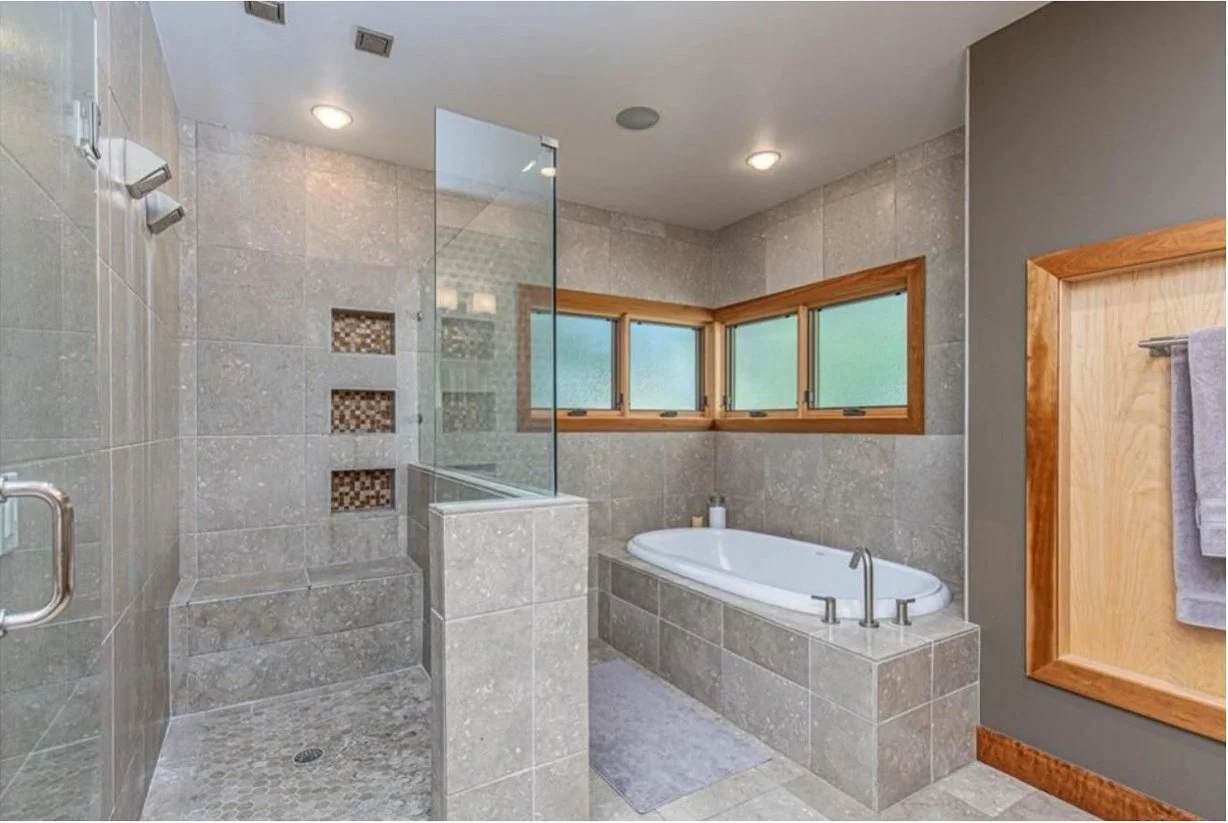 Original bathroom with beige tiled bath and framed windows