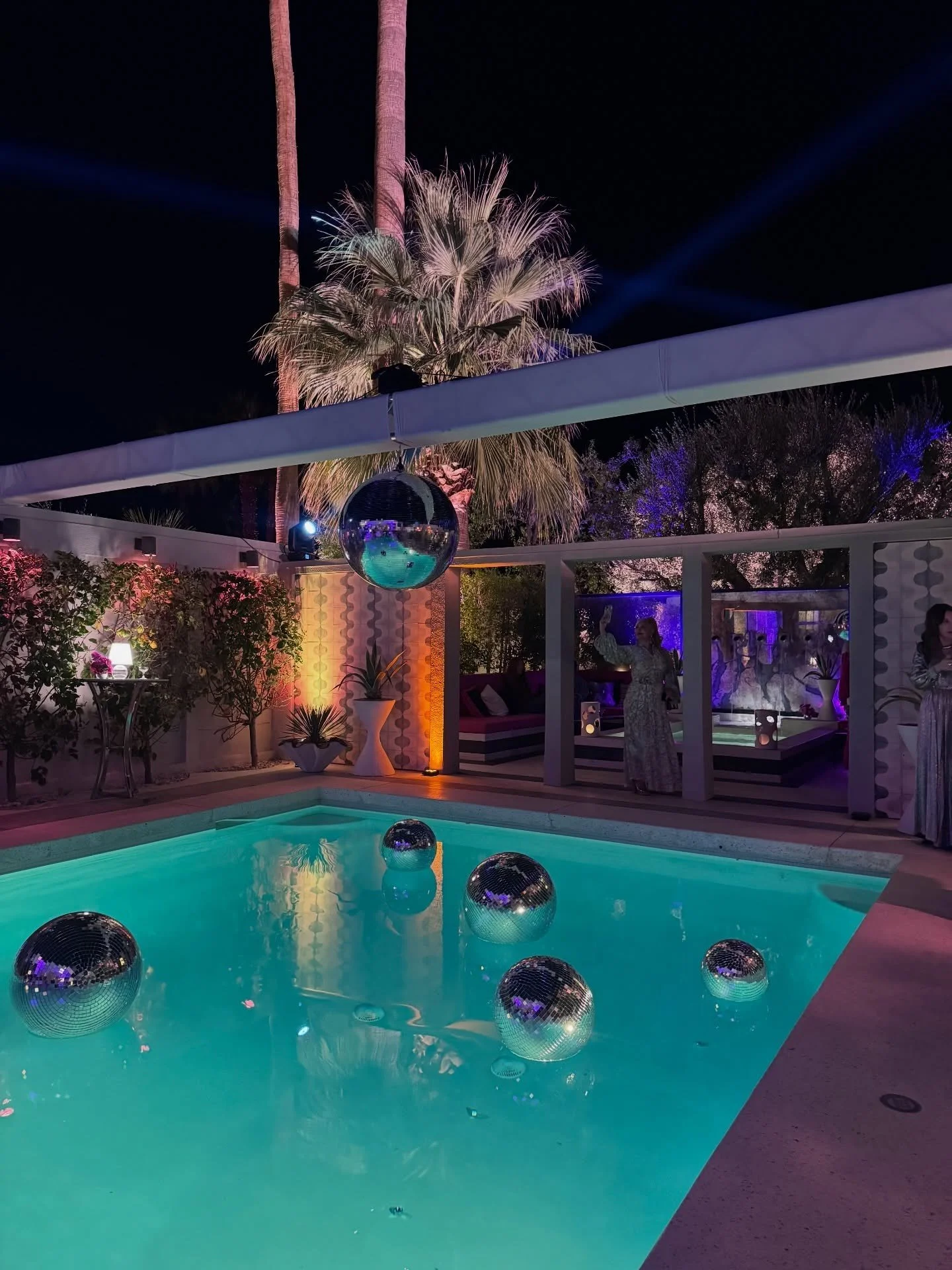 Pool courtyard with mirrored spheres and tropical planting