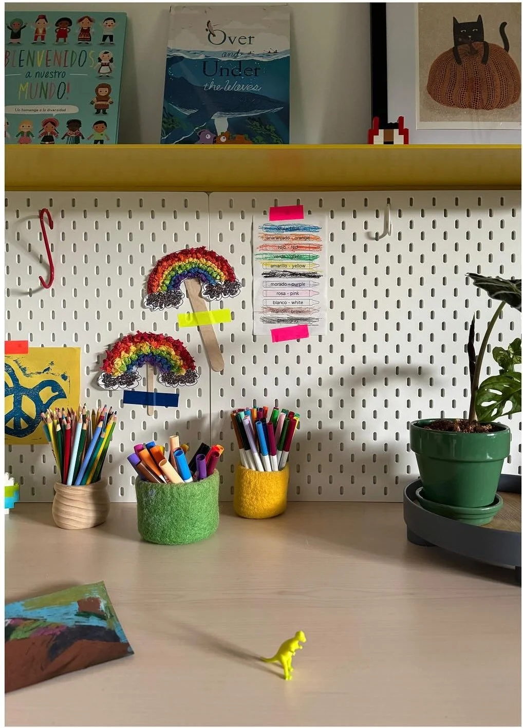 Craft counter with colored pencils pegboard and small artwork