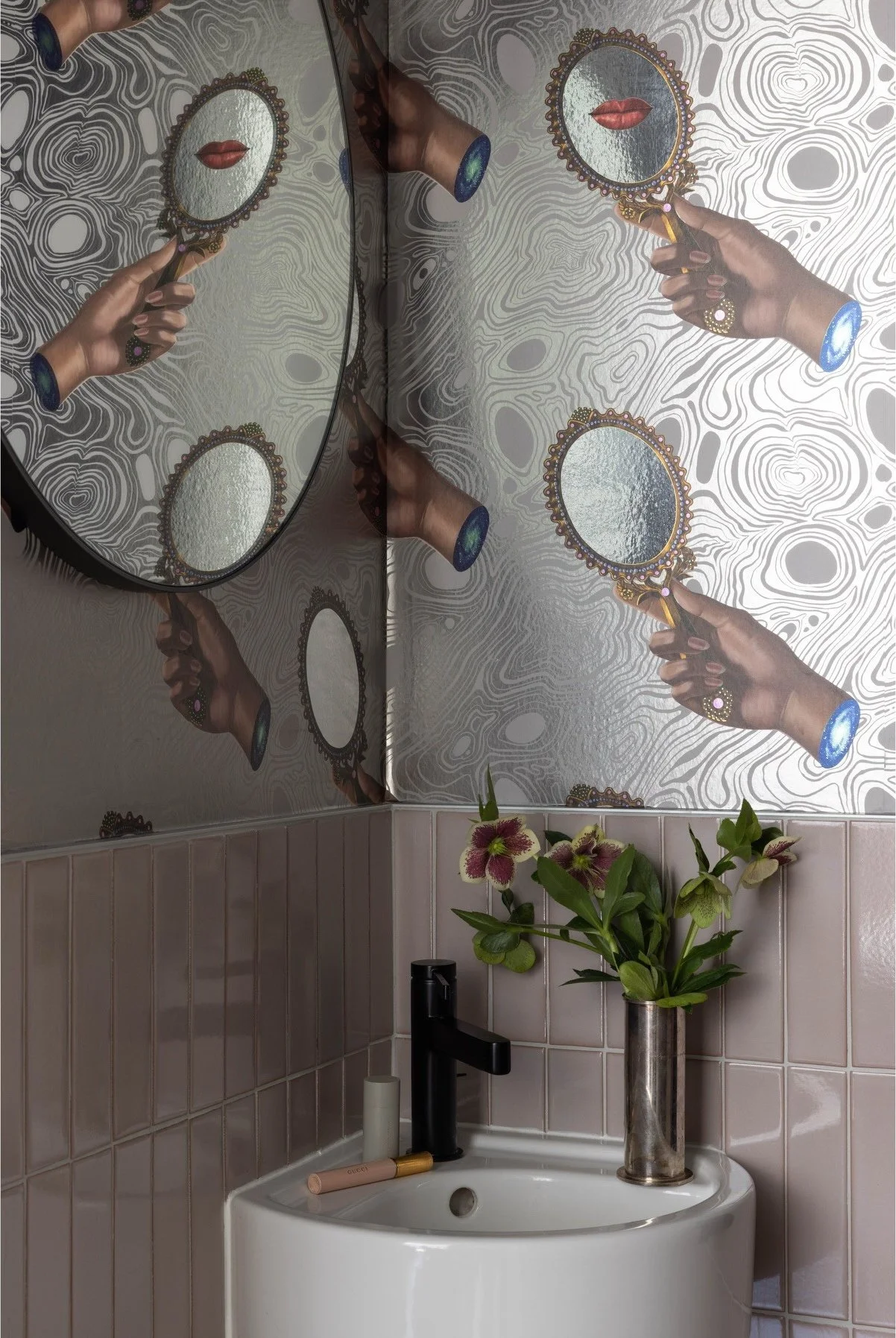 Powder room with monkey wallpaper and a small white basin