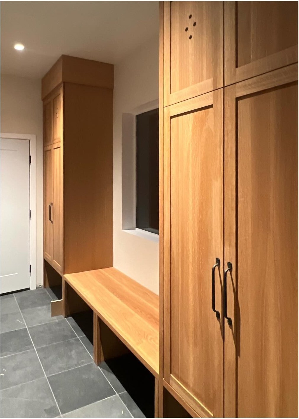 Original wood cupboards beside a dark tiled floor