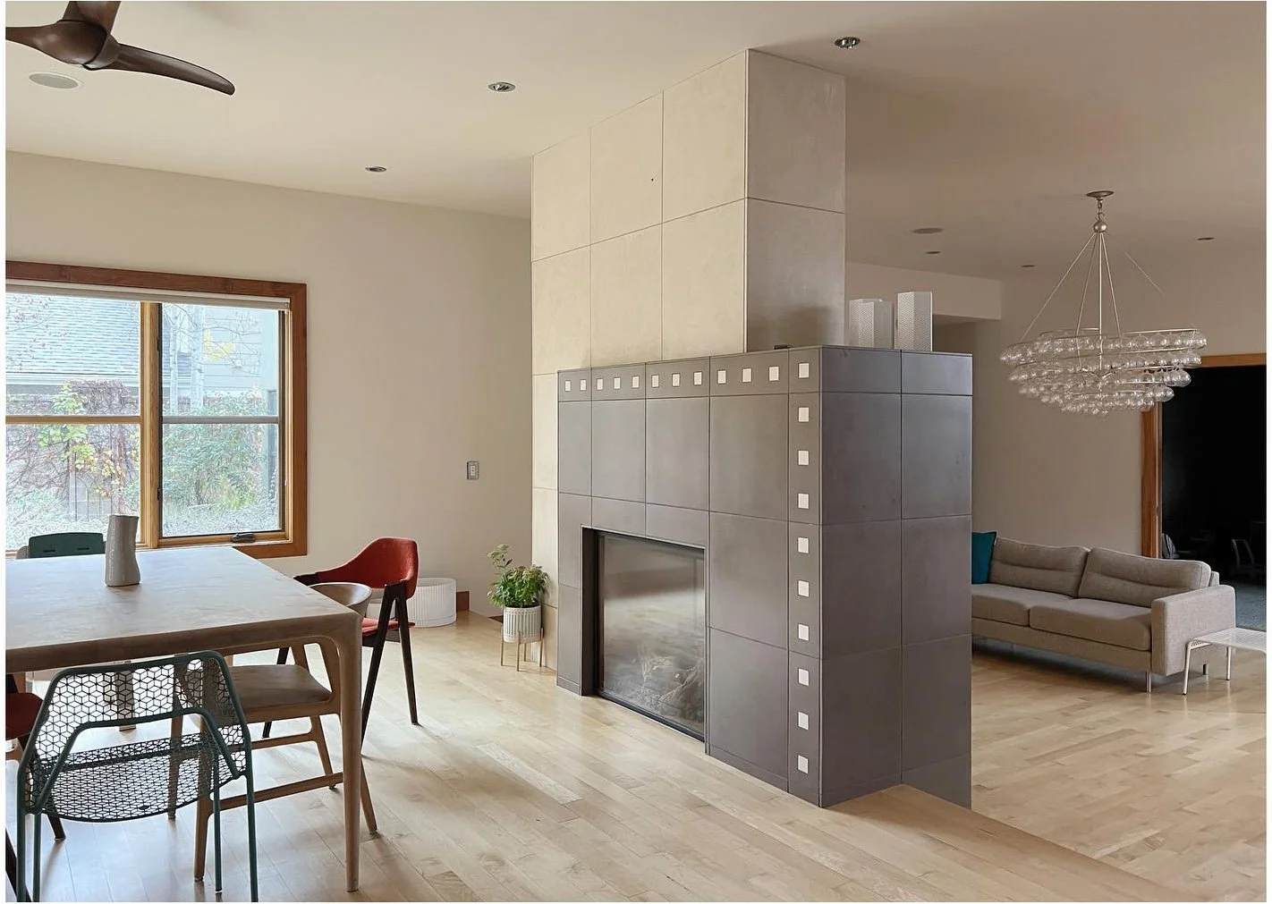 Original kitchen and dining area beside a dark central fireplace