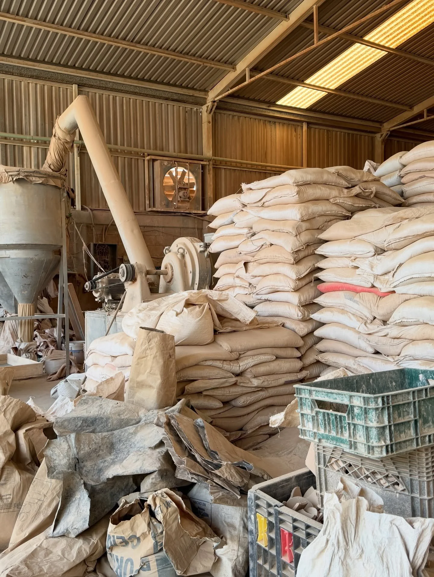Ceramic workshop with bags of material and production equipment