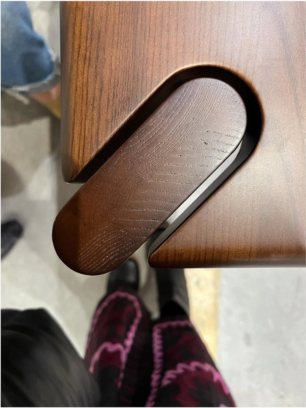 Close view of a curved black metal detail against a textured shade