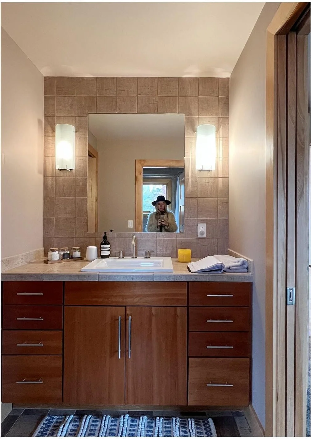 Original wood vanity and beige bathroom walls before renovation
