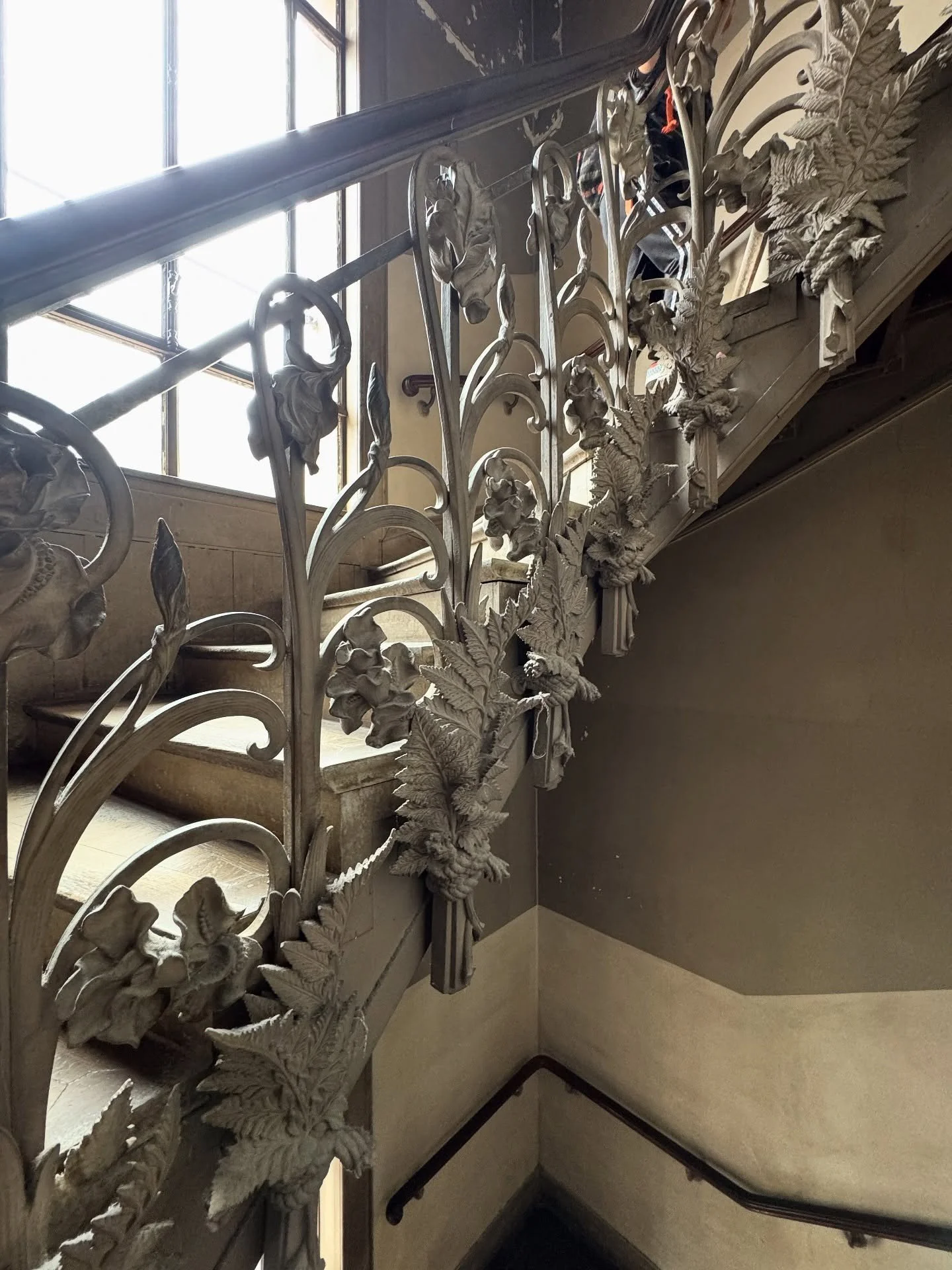 Ornate metal stair railing with leafy botanical motifs