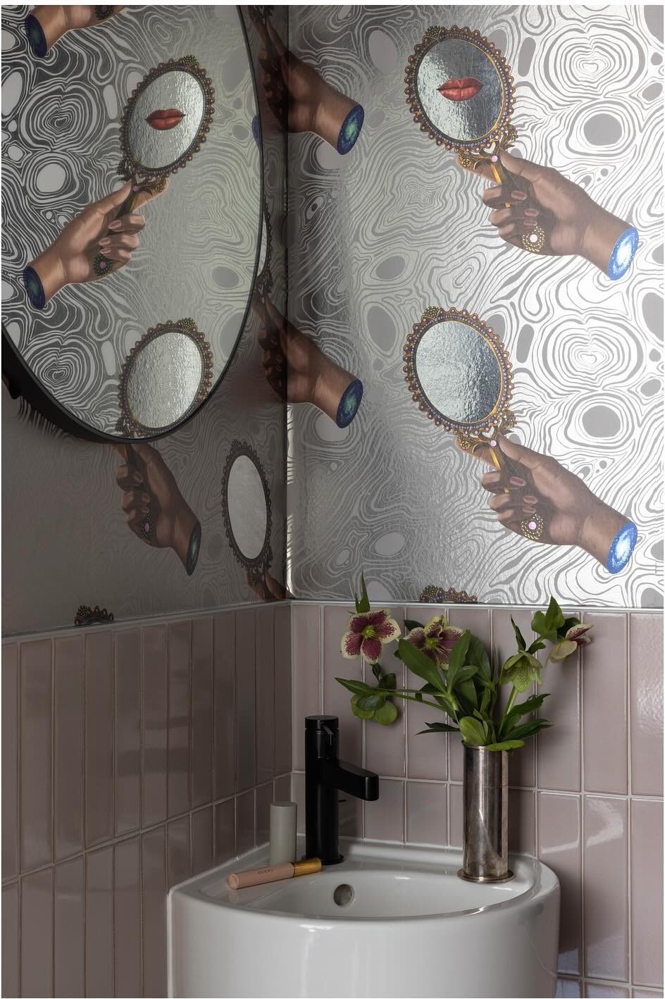 Monkey wallpaper around a small bathroom basin and mirrors