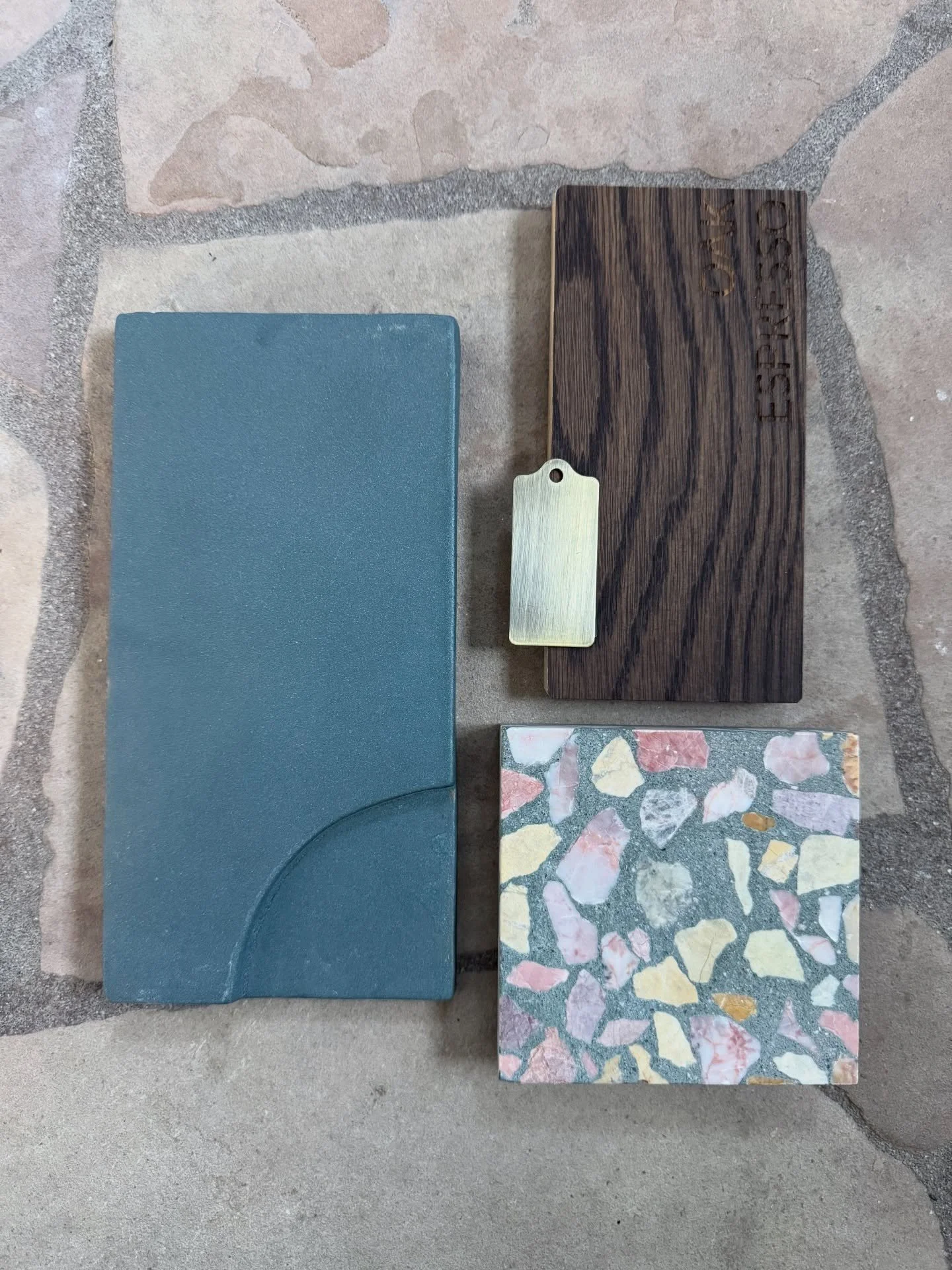 Blue relief tile beside striped wood and colorful terrazzo samples