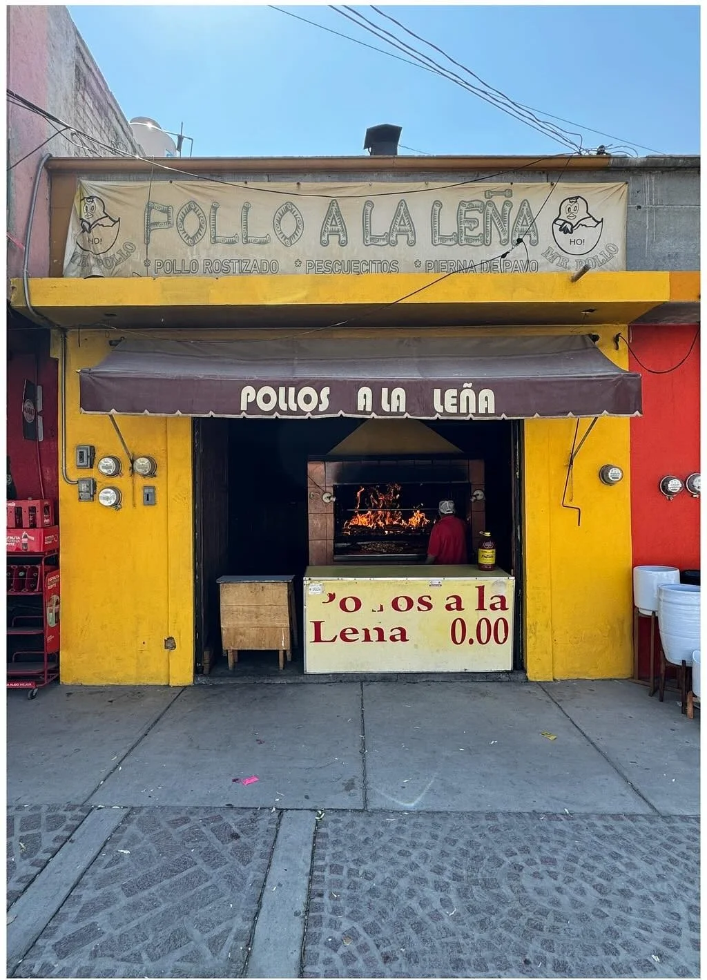 Yellow and red shopfront with a hand-painted sign