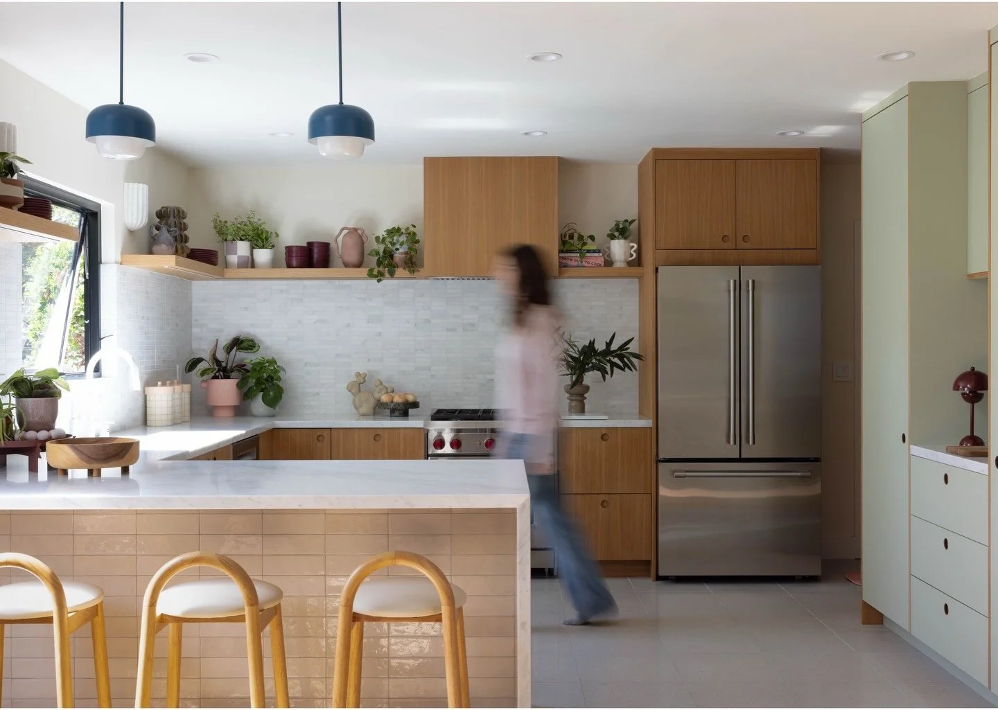 Oak kitchen island with woven stools and white counter